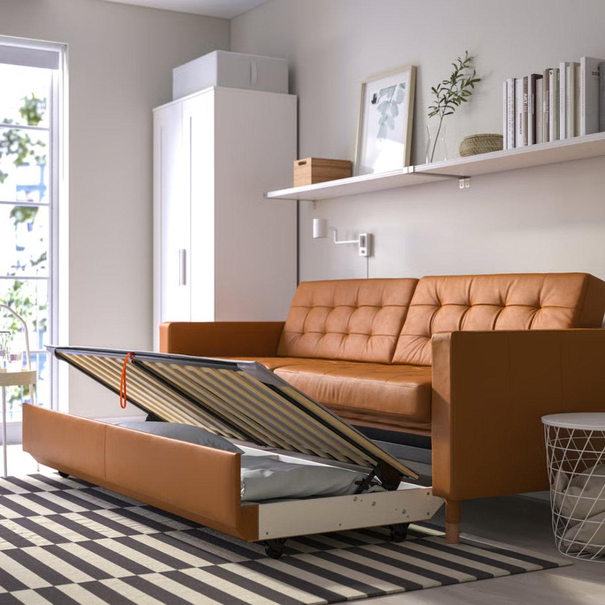 IKEA’s just slashed £500 off this stylish three-seater sofa bed – its clever underbed storage makes it a perfect choice for summer hosting